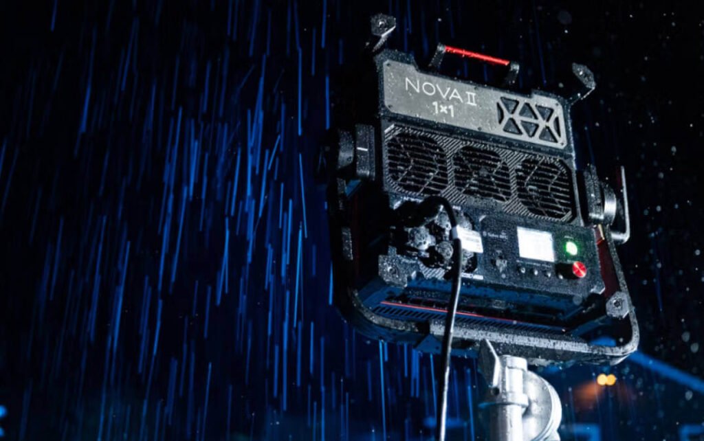 Aputure NOVA 9° professional LED panel light demonstrating IP65 weather resistance while projecting a narrow 9-degree blue beam through heavy rain.