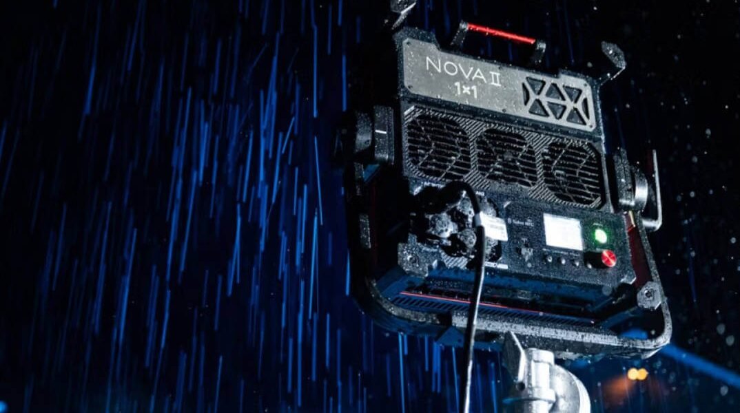 Aputure NOVA 9° professional LED panel light demonstrating IP65 weather resistance while projecting a narrow 9-degree blue beam through heavy rain.