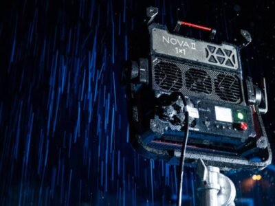 Aputure NOVA 9° professional LED panel light demonstrating IP65 weather resistance while projecting a narrow 9-degree blue beam through heavy rain.