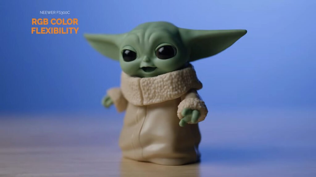 Hand adjusting control knobs on the rear panel of the red GVM PRO SD300C video light.