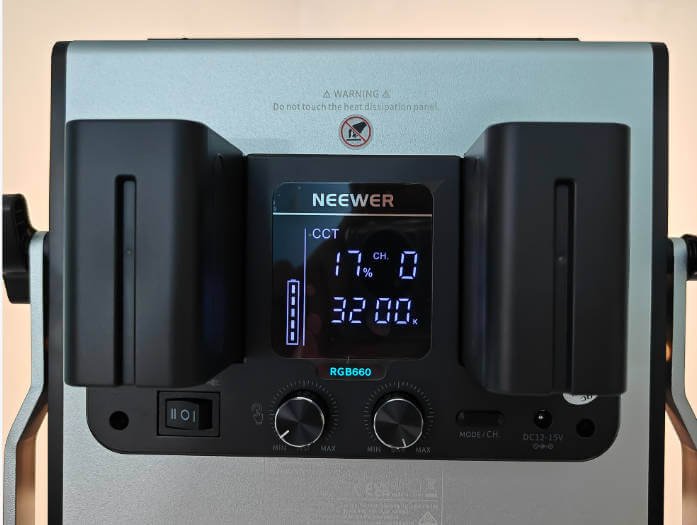 Close-up of the back panel of a Neewer LED video light, showing its LCD display with CCT and brightness controls, along with manual adjustment knobs.