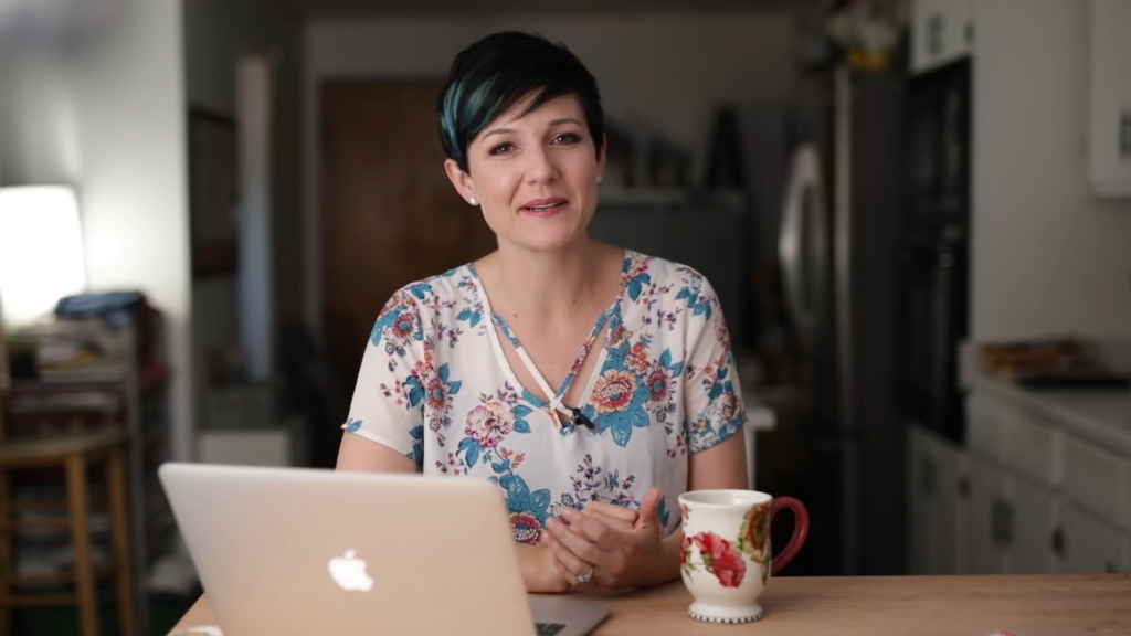 A woman explaining natural light for food photography setup near a window.